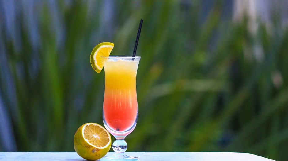 A glass pitcher of colorful non alcoholic summer drinks featured at the store