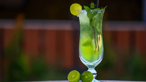 Free A vibrant mojito cocktail served with lime and mint leaves in a tall glass. Stock Photo