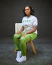 Woman in NYSC Uniform Seated on Chair
