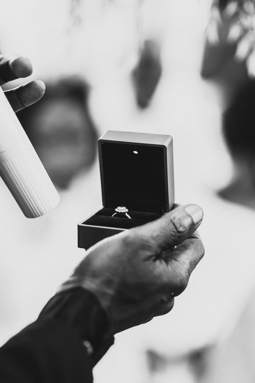Free Black and white photo of a hand presenting an engagement ring at a Ghanaian wedding ceremony. Stock Photo