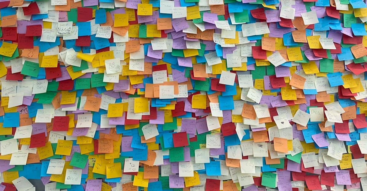 Bright and colorful sticky notes plastered on a wall, symbolizing creativity and brainstorming.