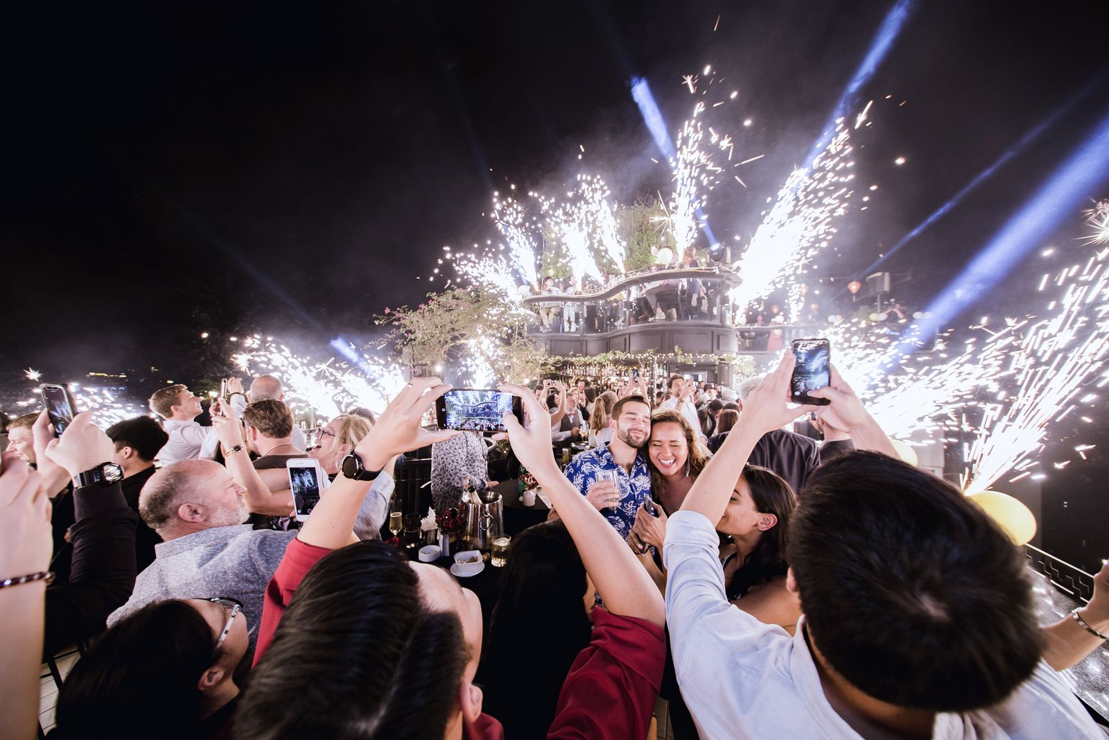 Crowd celebrating at a premium night event with fireworks in Delhi NCR