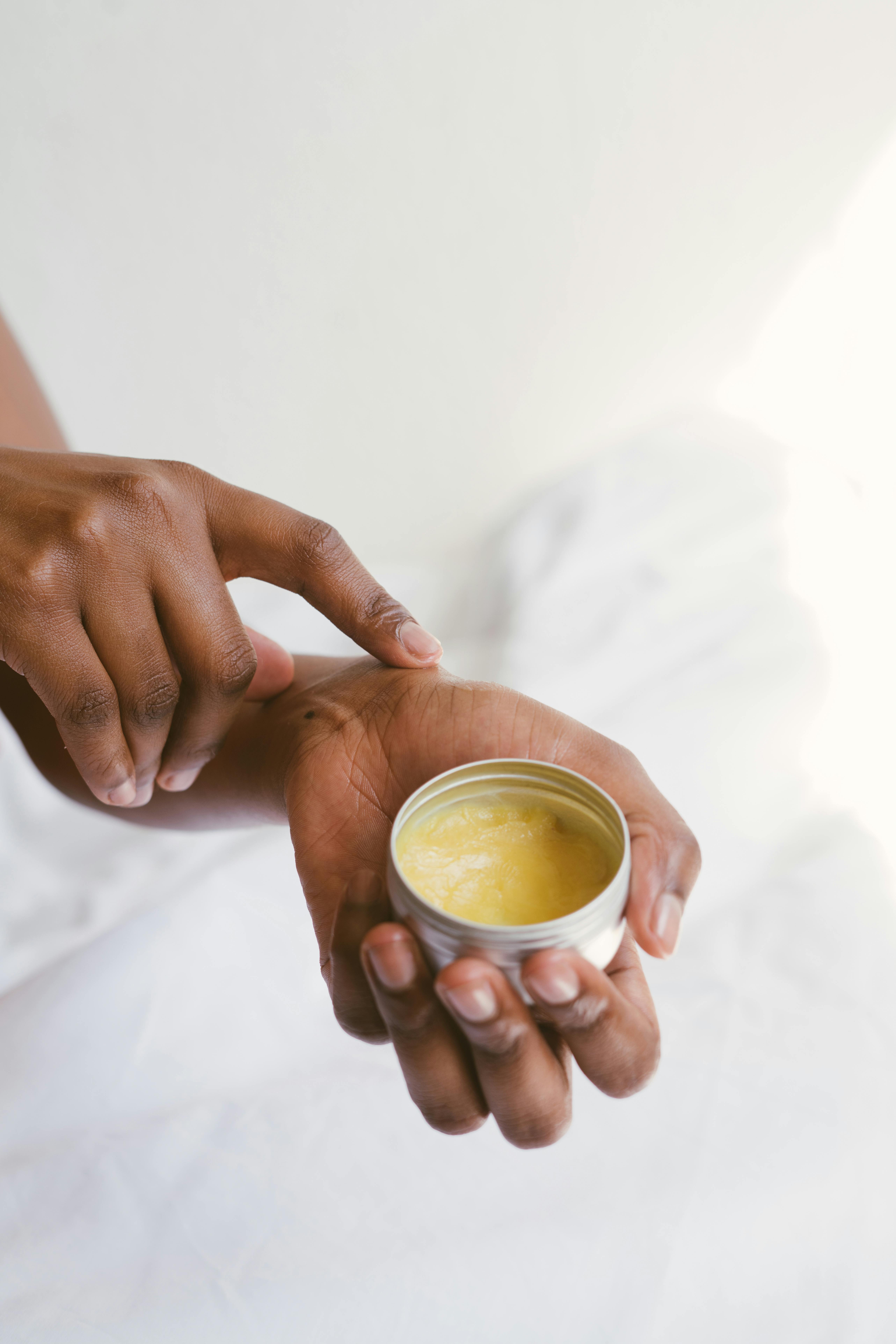 person holding a hand cream