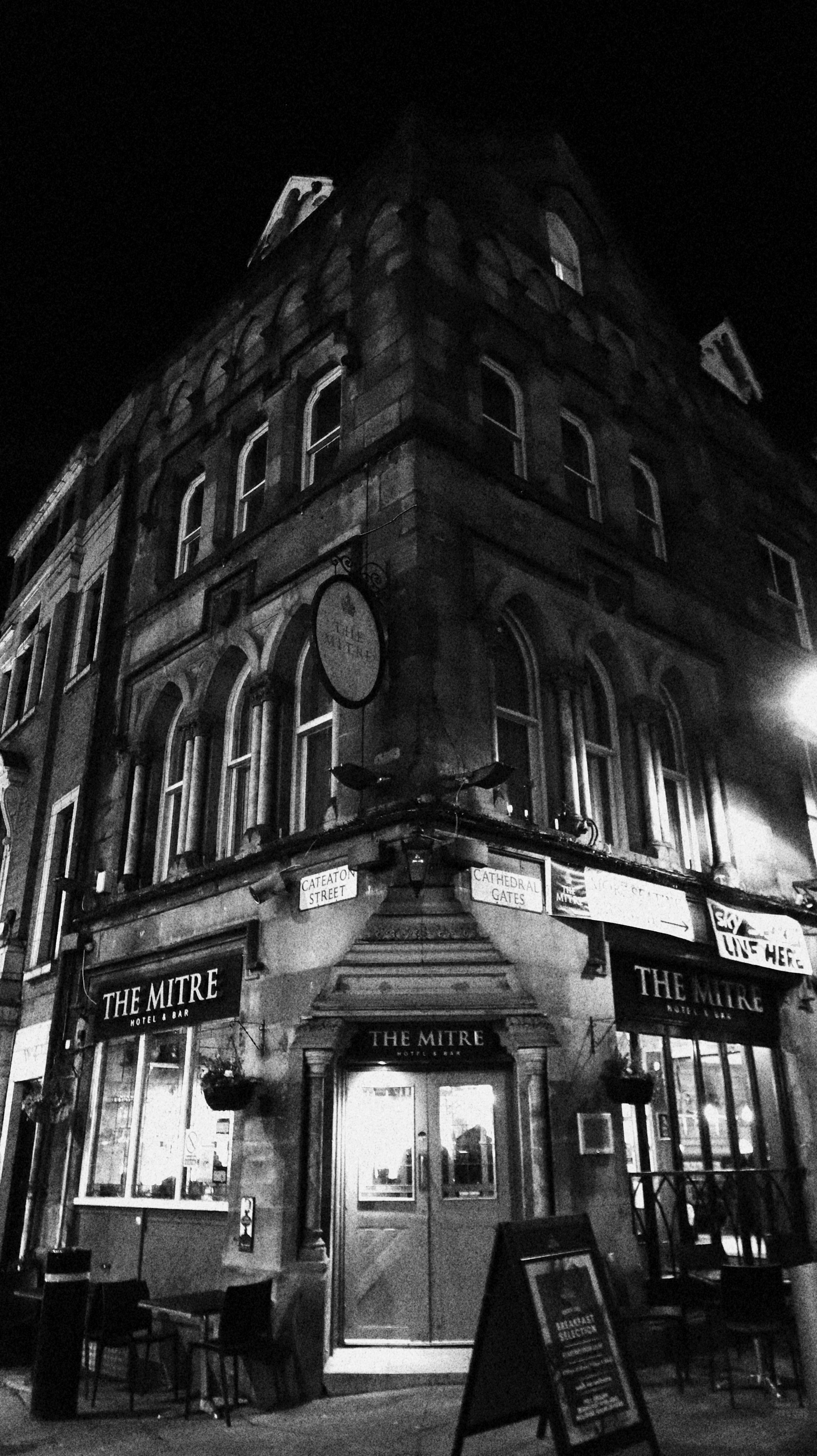 Elegant historic pub facade captured at night in striking black and white.