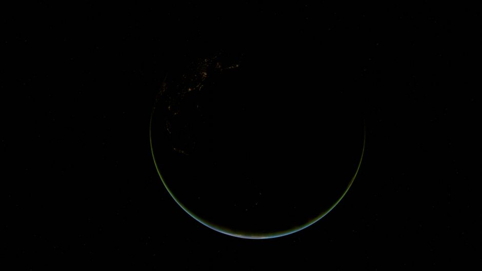Stunning crescent view of Earth at night, highlighting city lights and vast oceans.