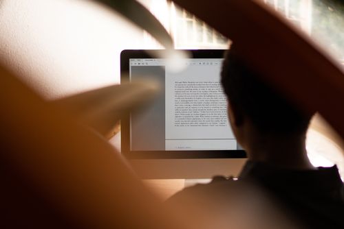 Free Silhouette of a person working from home on a computer, highlighting remote work lifestyle. Stock Photo