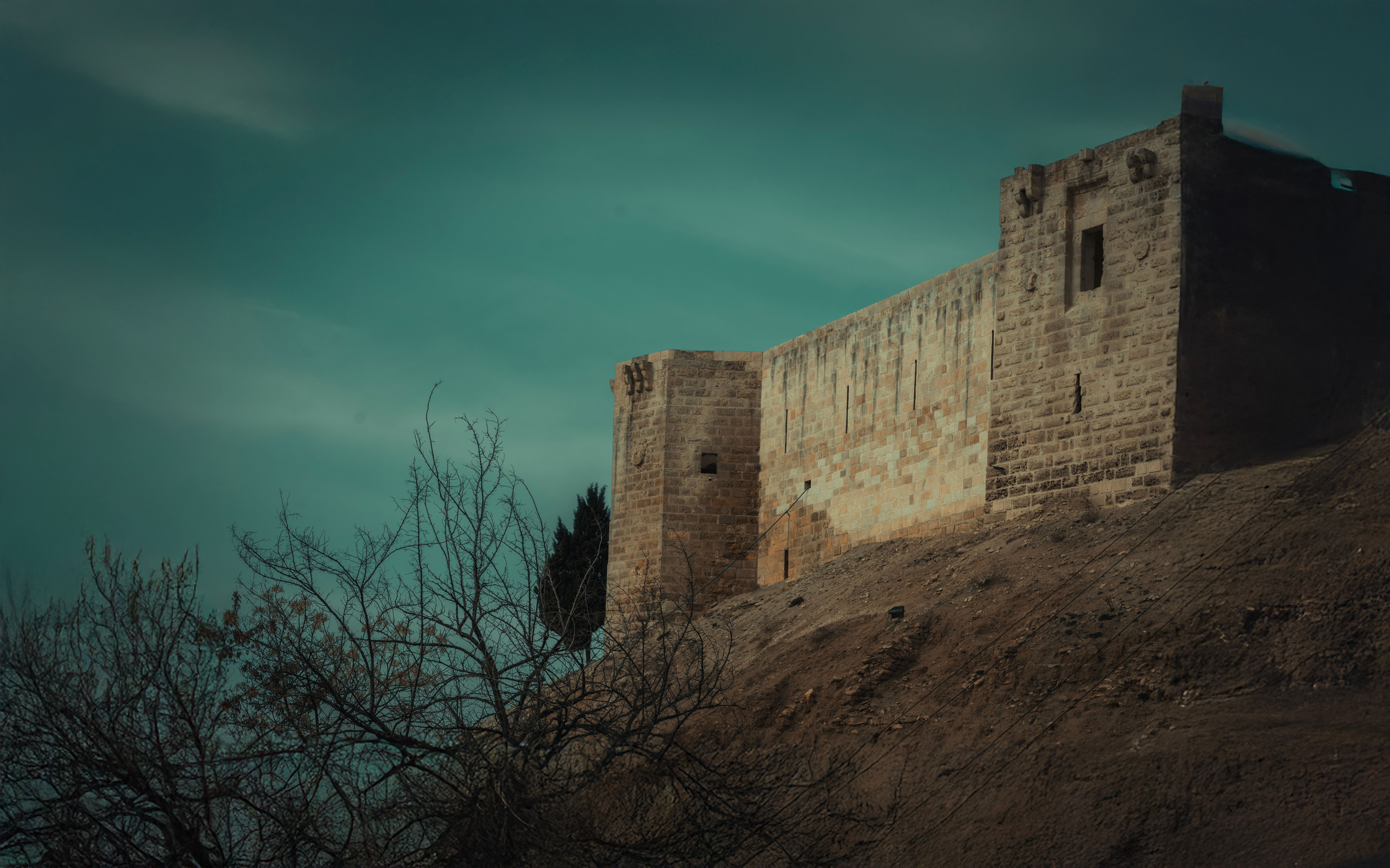 Medieval Castle on a Hill Under Dramatic Sky · Free Stock Photo
