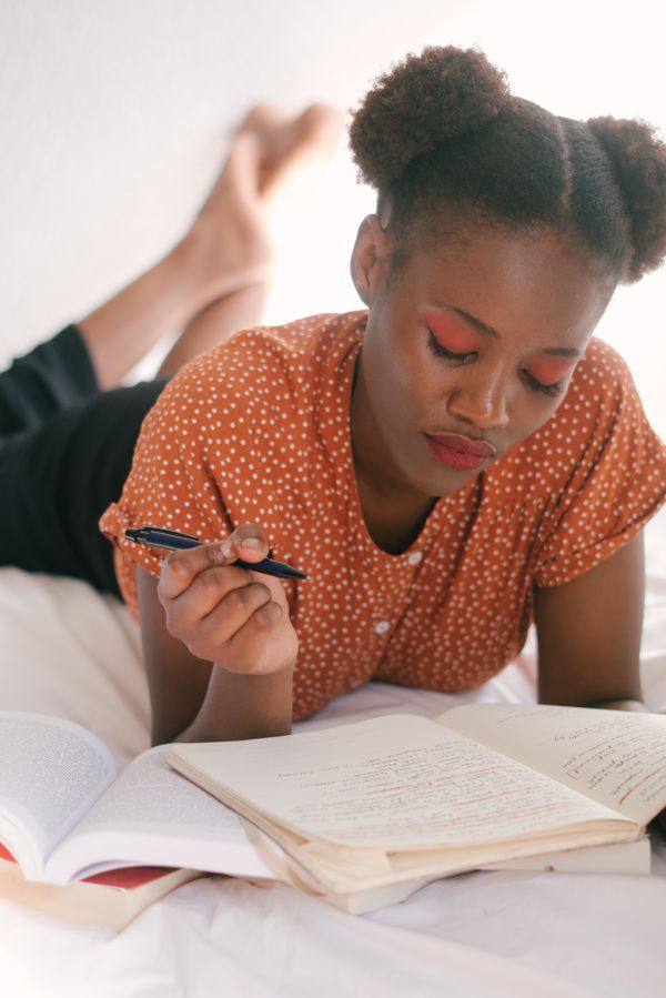 Woman writing in a notebook, relaxed