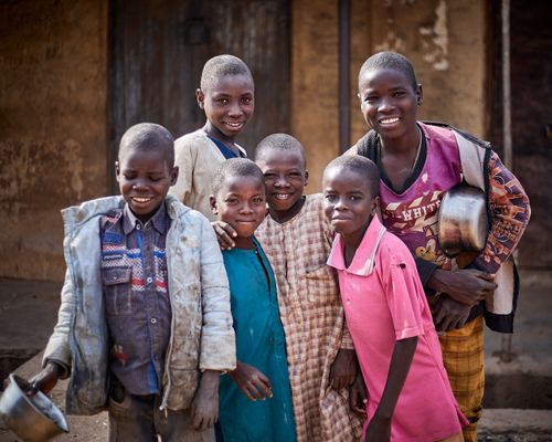 Free A joyful group of children smiling and posing outside, portraying diversity and friendship. Stock Photo