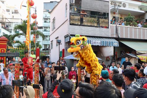 Free A lively lion dance performance in a street festival attracting a diverse crowd. Stock Photo