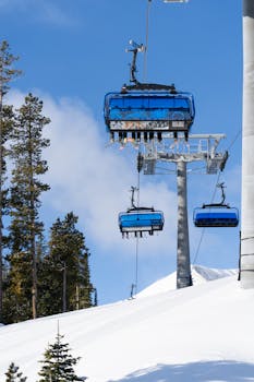 Ski lift ascending snow-covered mountains in Big Sky, Montana. Perfect for winter sports enthusiasts.