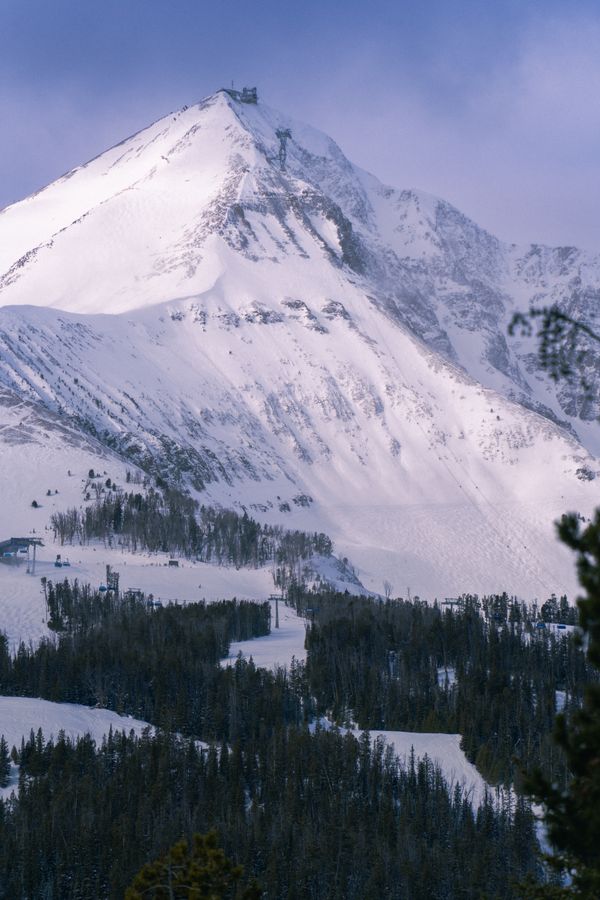 Snow-covered mountain peak above a ski slope in Montana during winter