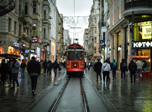 Free A vibrant red tram travels along historic Istiklal Street in Istanbul, bustling with people and classic architecture. Stock Photo