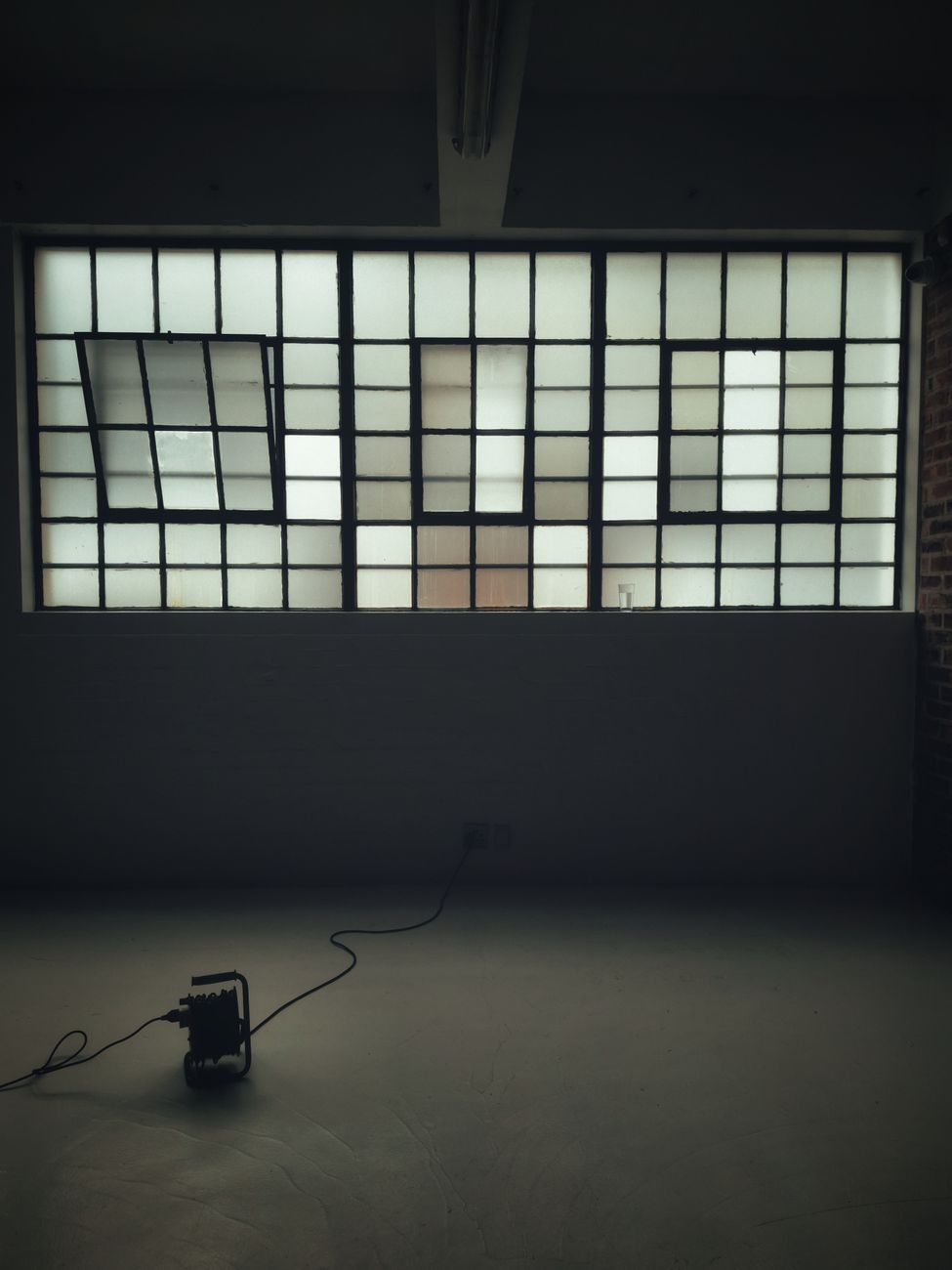A minimalist industrial loft with large grid windows and a floor object, offering a modern and spacious feel.. pexels, minima