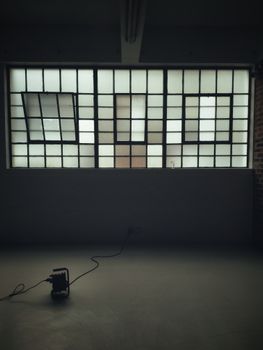 A minimalist industrial loft with large grid windows and a floor object, offering a modern and spacious feel.. pexels, minima