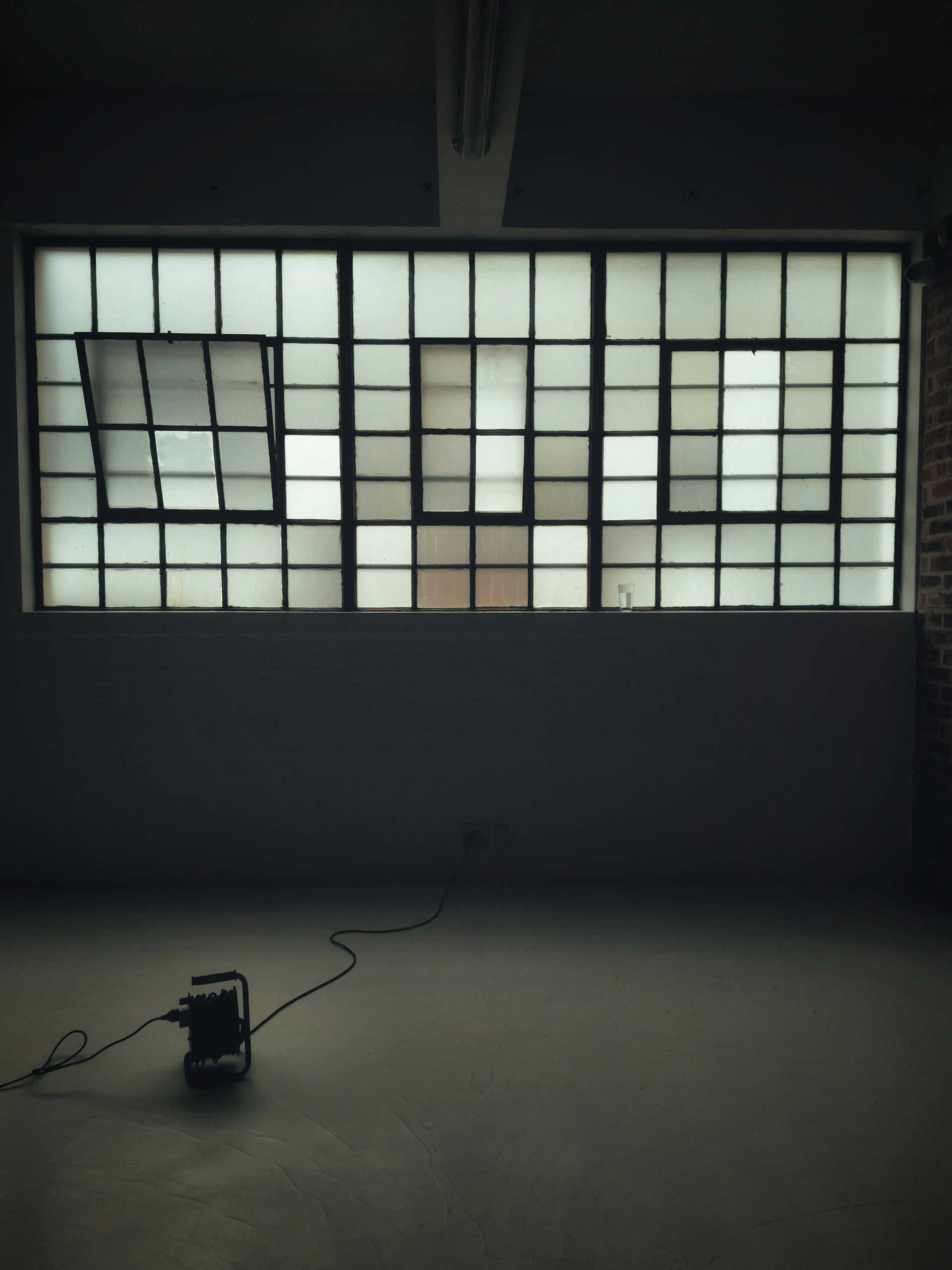 A minimalist industrial loft with large windows and natural light