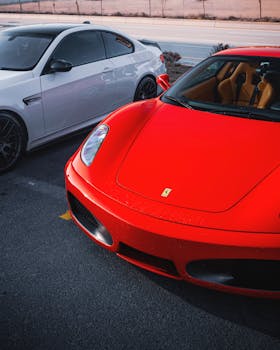 A vibrant red Ferrari parked next to a white BMW on a sunny day in Ankara, Türkiye.