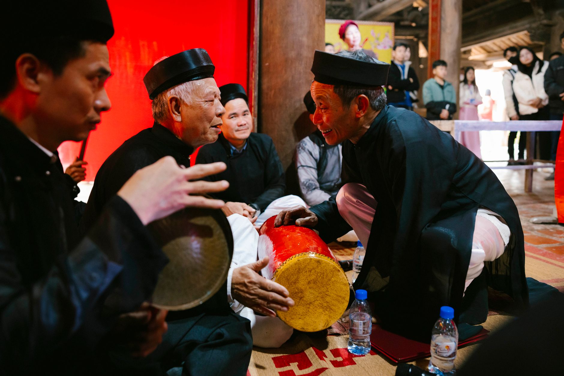 Elderly musicians performing traditional Vietnamese music indoors, capturing cultural heritage.