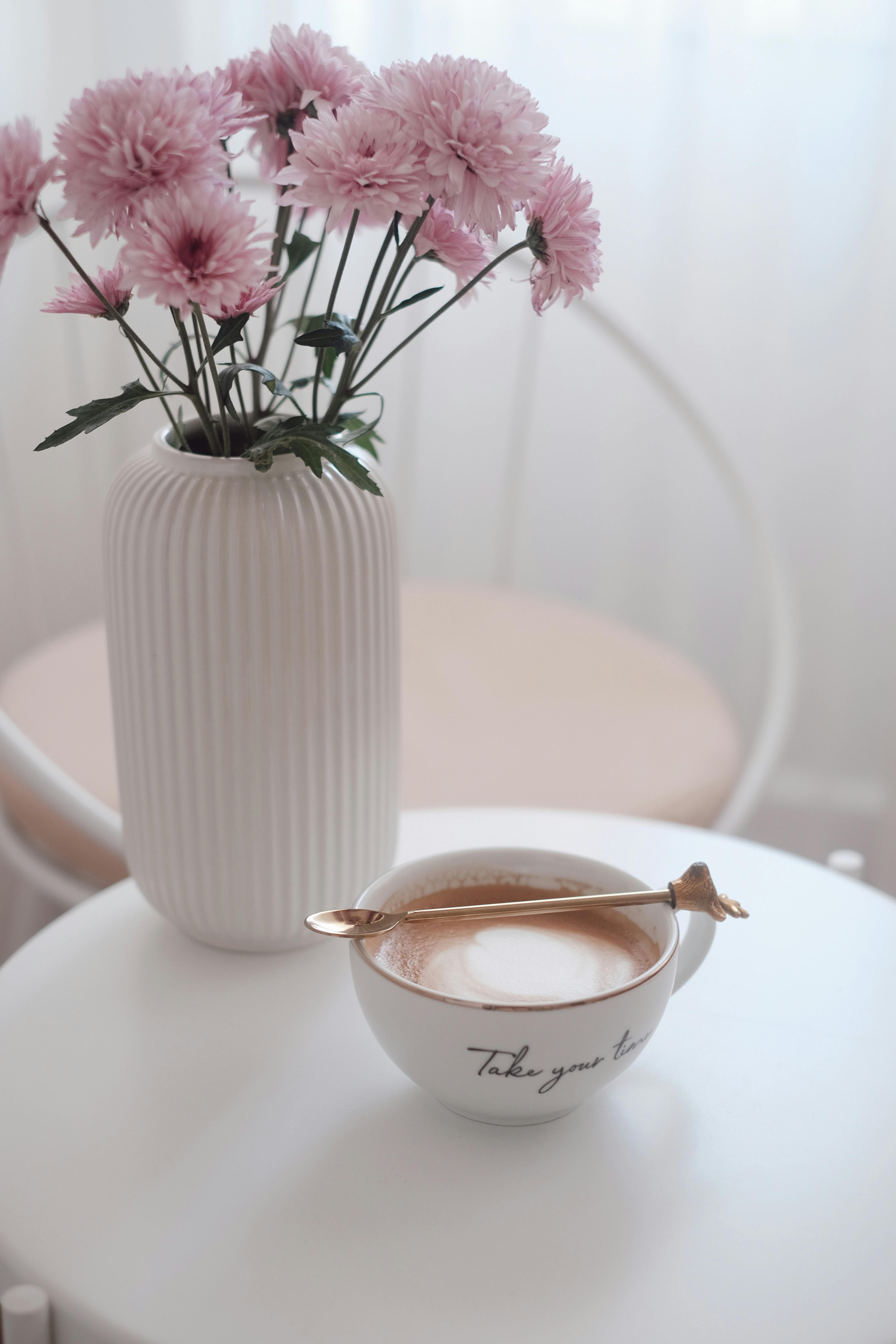 elegant coffee and pink flowers in minimalist setting