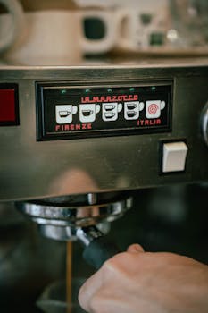 A barista operates a La Marzocco espresso machine, highlighting its detailed control panel.