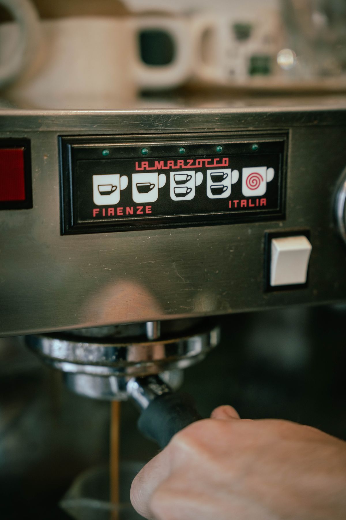 Barista operating a high-end commercial espresso machine, for illustration