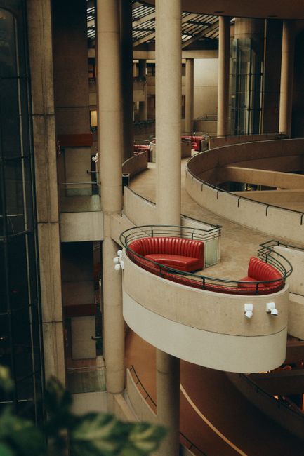 Dynamic view of Los Angeles' brutalist architecture showcasing modern design with red seating.