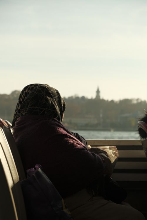 Free A senior woman on an Istanbul ferry admiring the Bosphorus views on a sunny day. Stock Photo