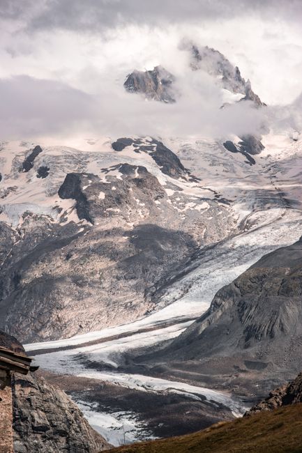 Stunning snowcovered mountain view from Täsch, Wallis, with clouds and glaciers.
