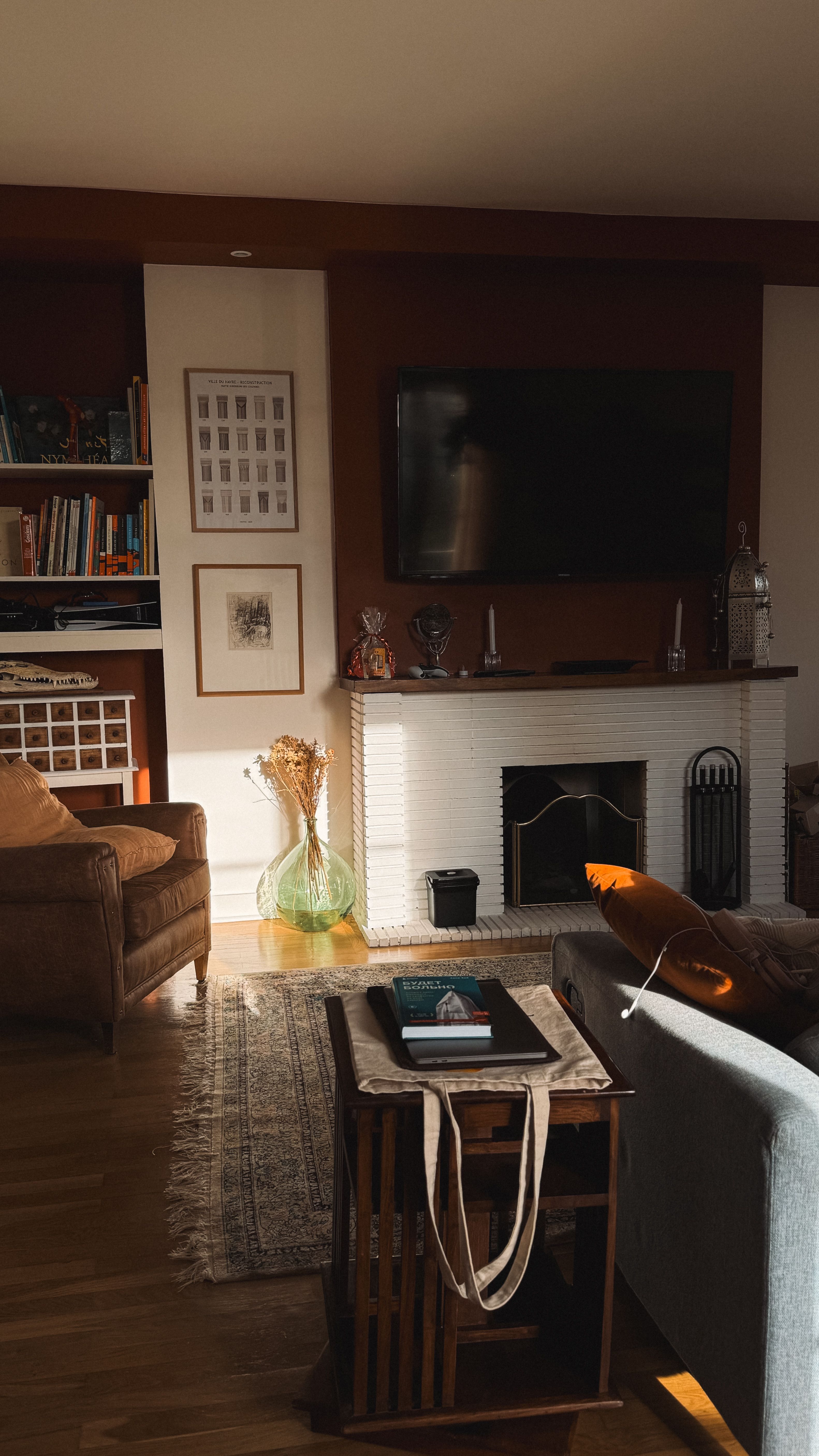 Warm cozy living room with fireplace, sunlight, and modern decor.