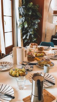 Inviting breakfast spread on a dining table with natural light flooding in.