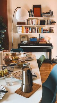 Warm and inviting home space with dining table and piano.