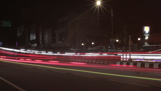 Dynamic city street lights captured through long exposure at night.