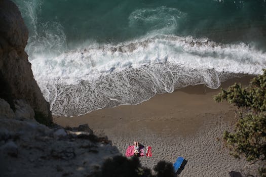 Aerial shot of a tranquil beach with turquoise waves, perfect for a quiet escape.