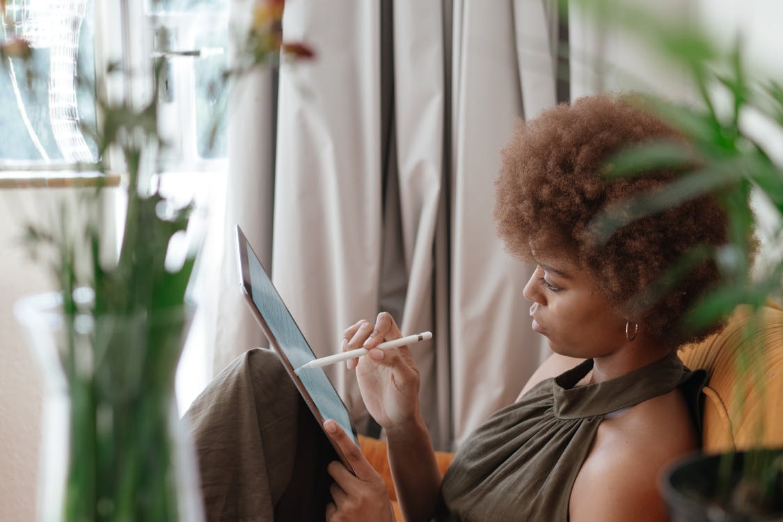 Photo Of Woman Using Tablet to Read