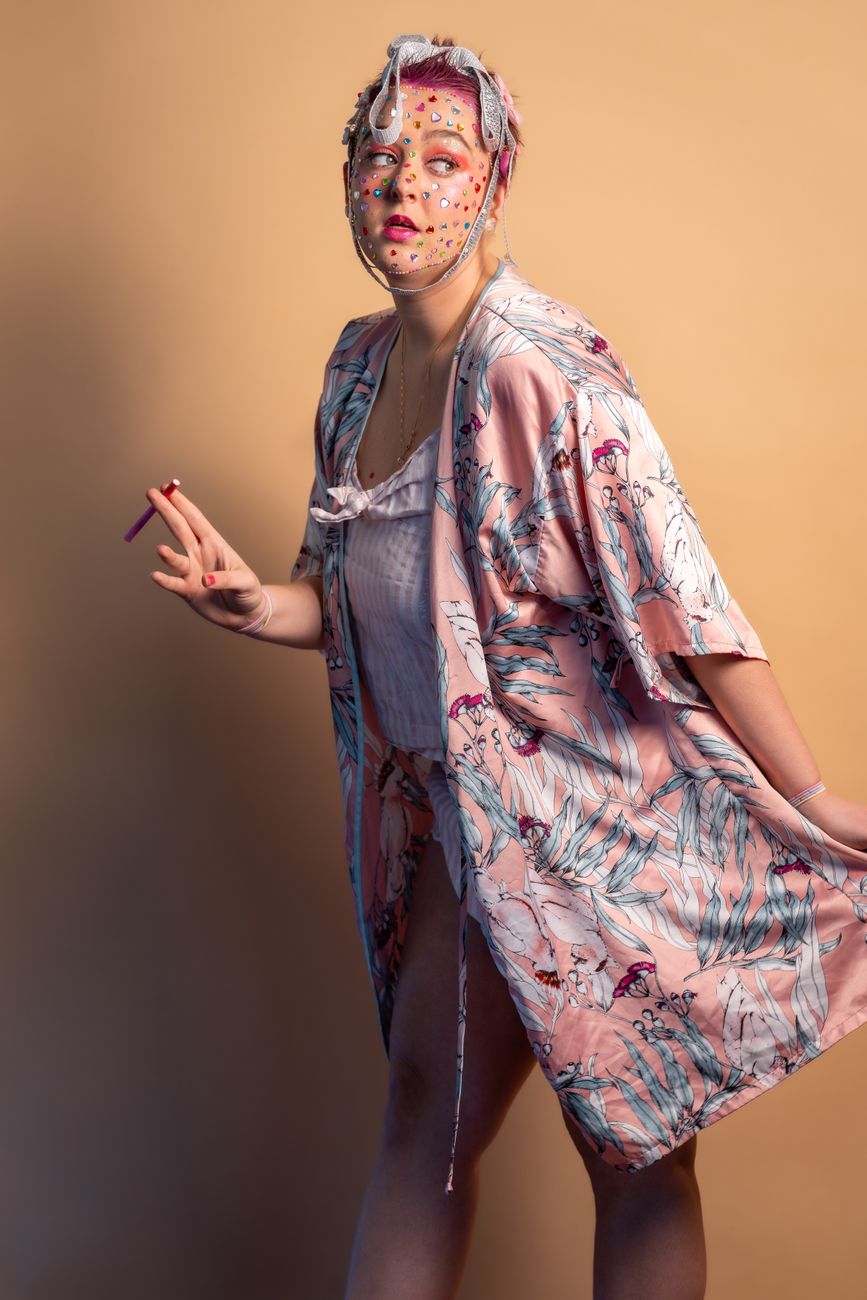 Portrait of a woman in a colorful kimono, artistic makeup, motion pose.