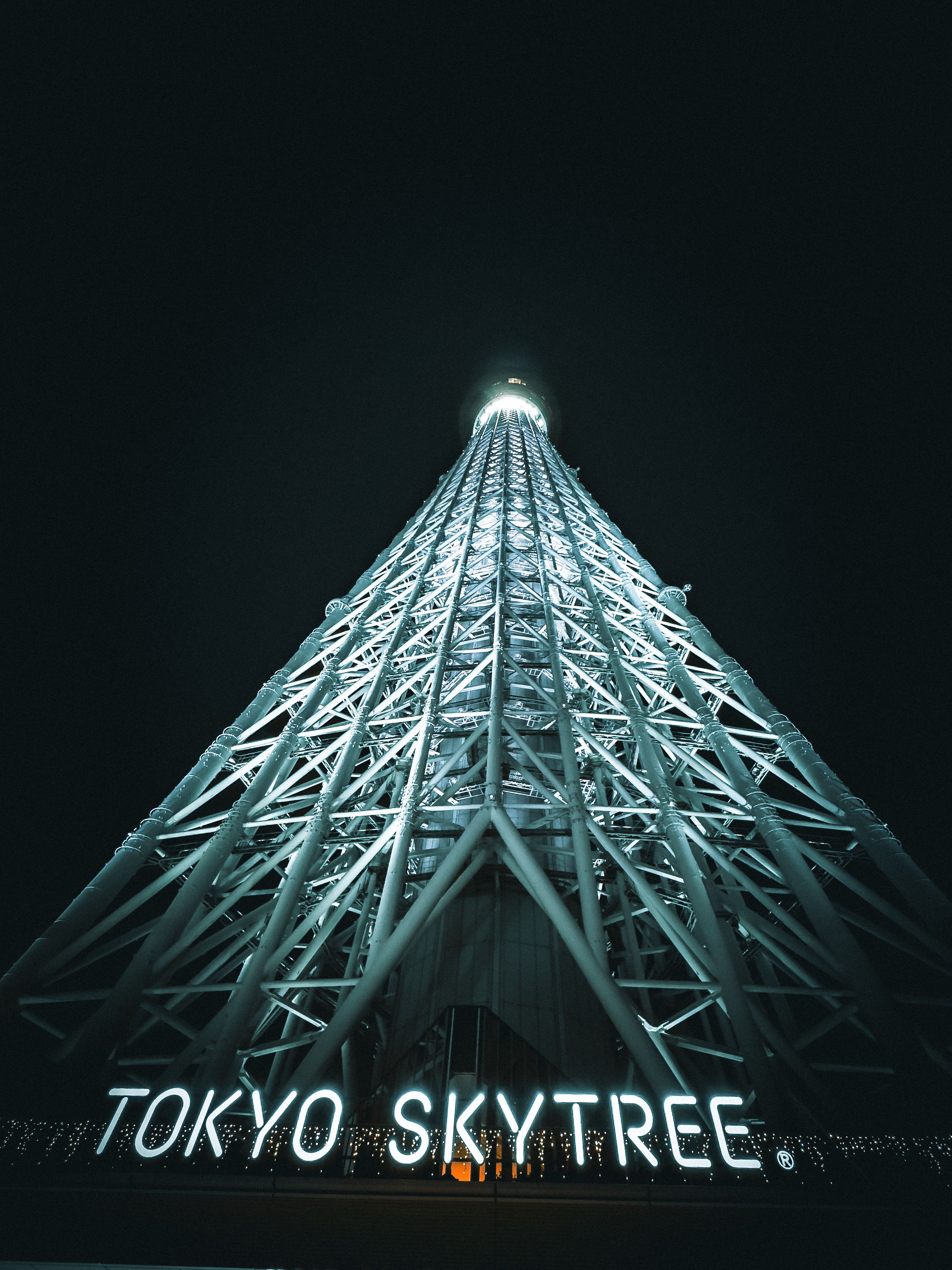 A striking nighttime view of the lit-up Tokyo Skytree, showcasing its modern architecture.