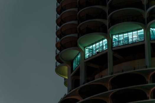 Close-up of illuminated building architecture at night with a modern design.