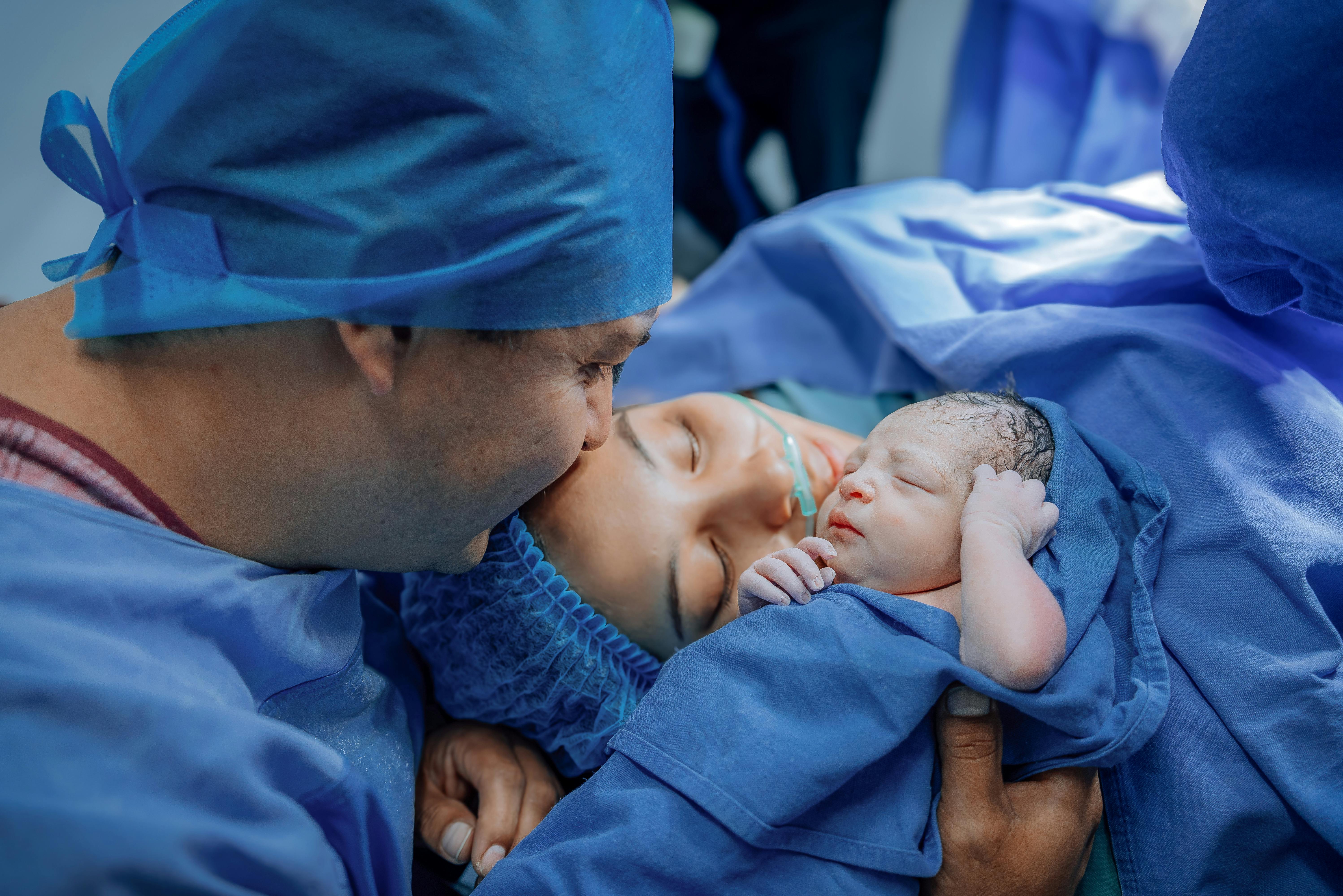 Mother bonding with newborn baby after birth through skin-to-skin contact promoting emotional attachment and newborn stability