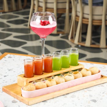 Vibrant display of Indian street food fusion with colorful drinks served on a stylish platter.