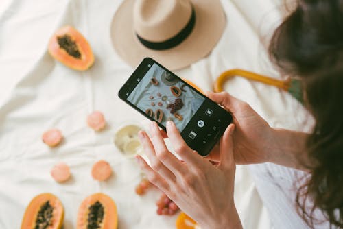 Free Photo Of Person Taking Picture Of Fruits Stock Photo