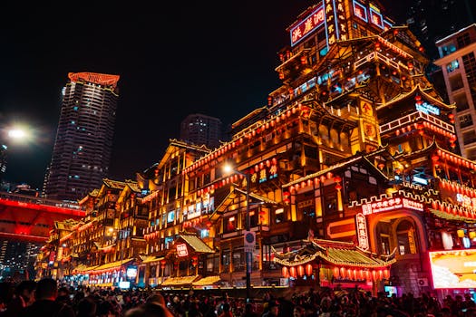 Vibrant view of Hongya Cave in Chongqing, China lit up at night, showcasing traditional Chinese architecture.