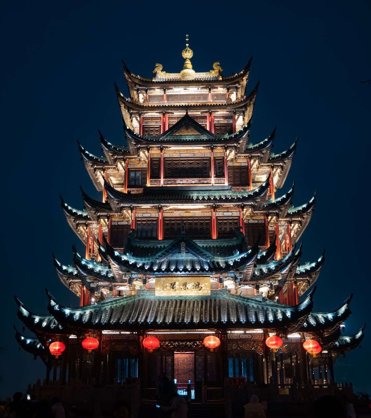 A traditional Chinese pagoda glowing with red lanterns at night