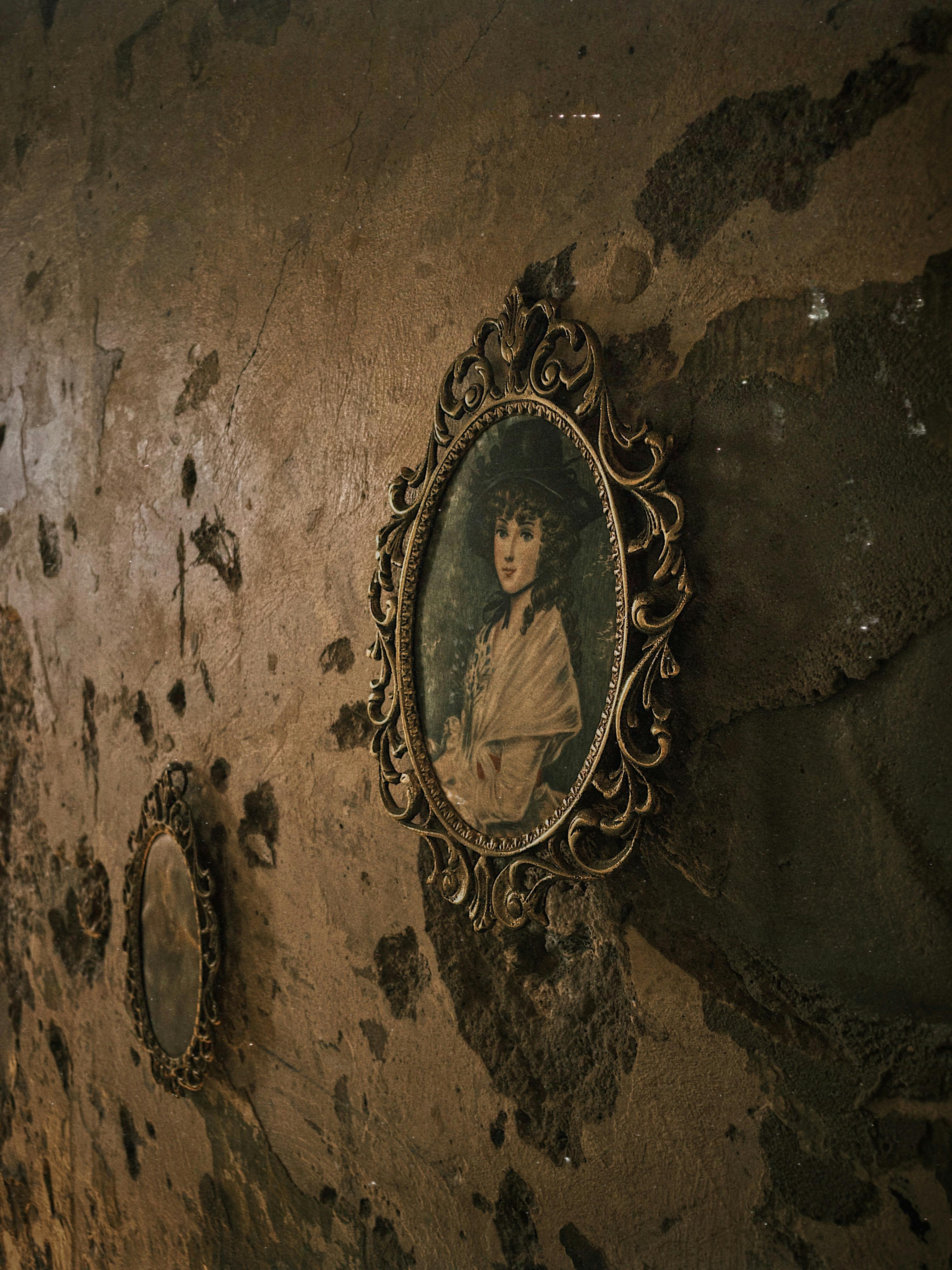 An ornate vintage portrait frame hangs on a textured, rustic wall adding classic charm.