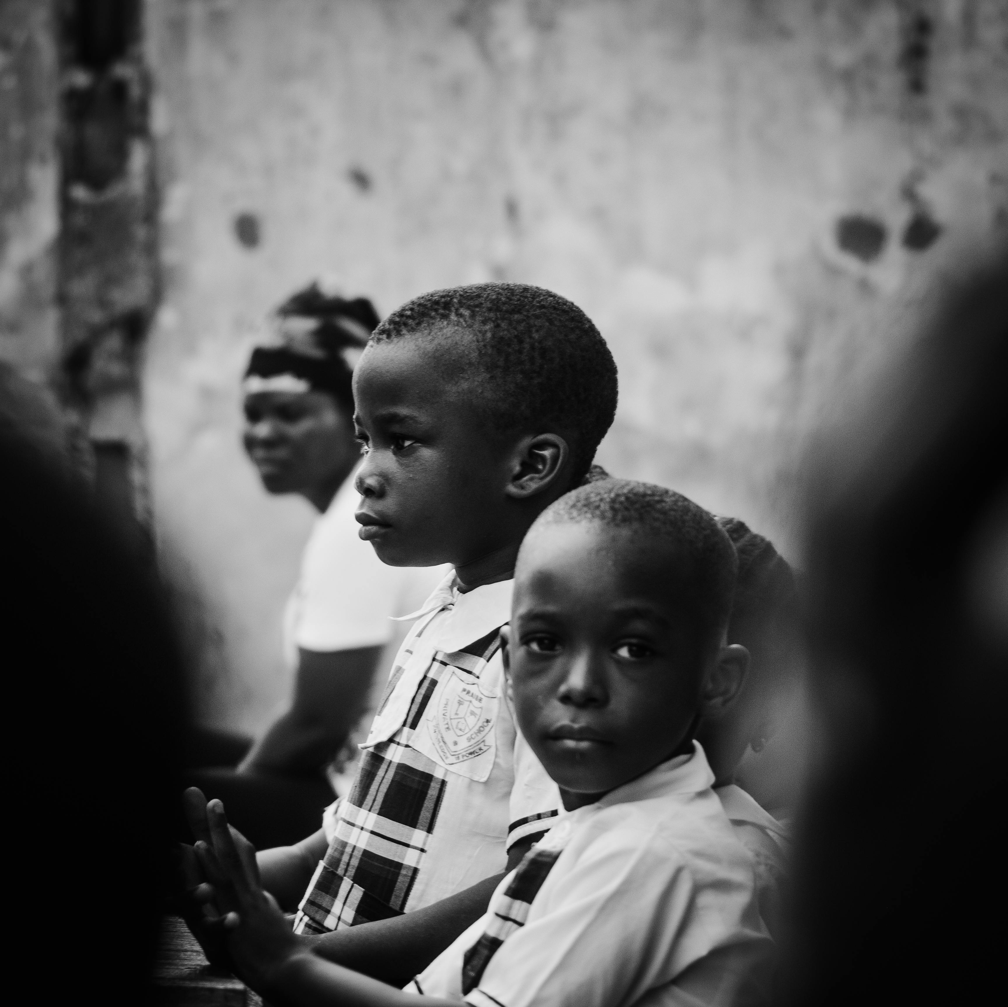 A poignant black and white portrait depicting thoughtful expressions of young children.