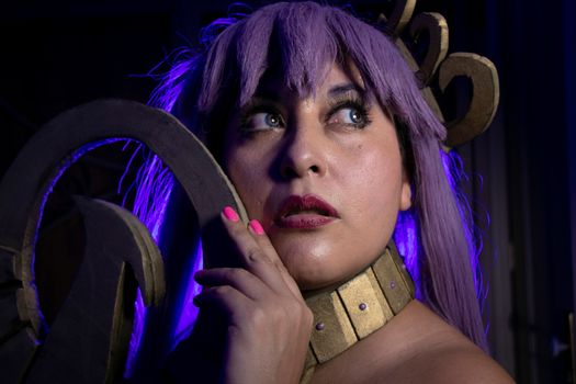 Creative cosplay portrait featuring a person with vibrant purple hair and accessories.