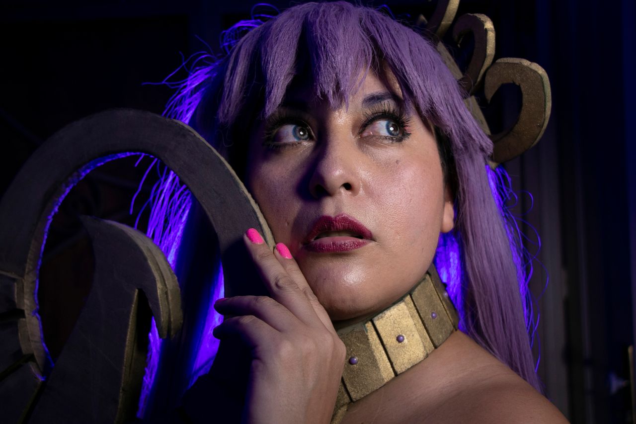 creative cosplay portrait featuring a person with vibrant purple hair