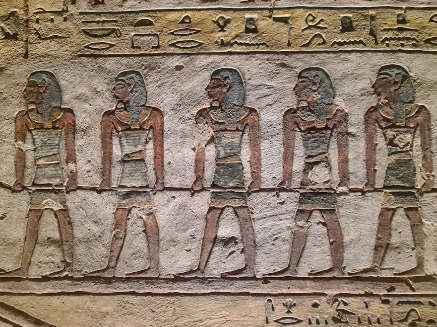Stone relief of ancient Egyptian figures and hieroglyphs from Luxor, Egypt, showcasing historical artistry.