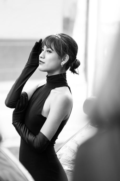 Free Elegant woman with tiara in black dress and gloves, classic style. Stock Photo