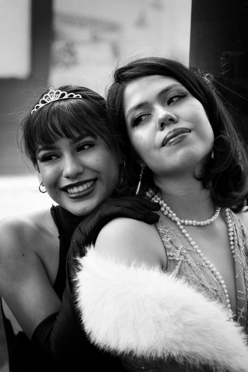 Free Chic black and white photo of two smiling women in vintage attire. Stock Photo