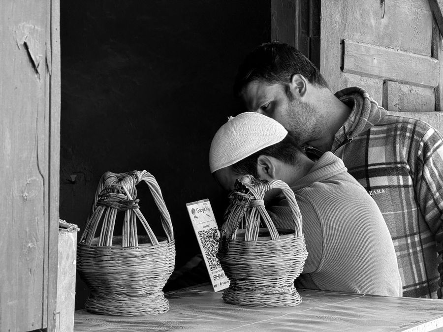 Indian customers using QR payment at a local market counter